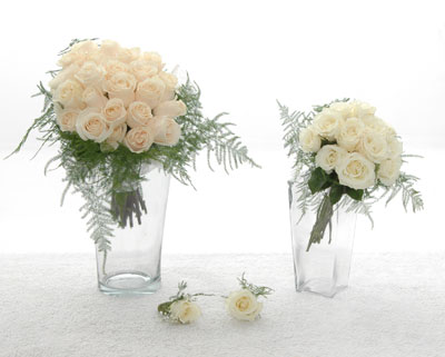 A delicate handtied bouquet of 2 dozen roses ribbon and fern